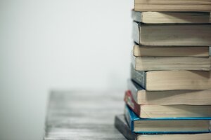 Stack of books on wooden table